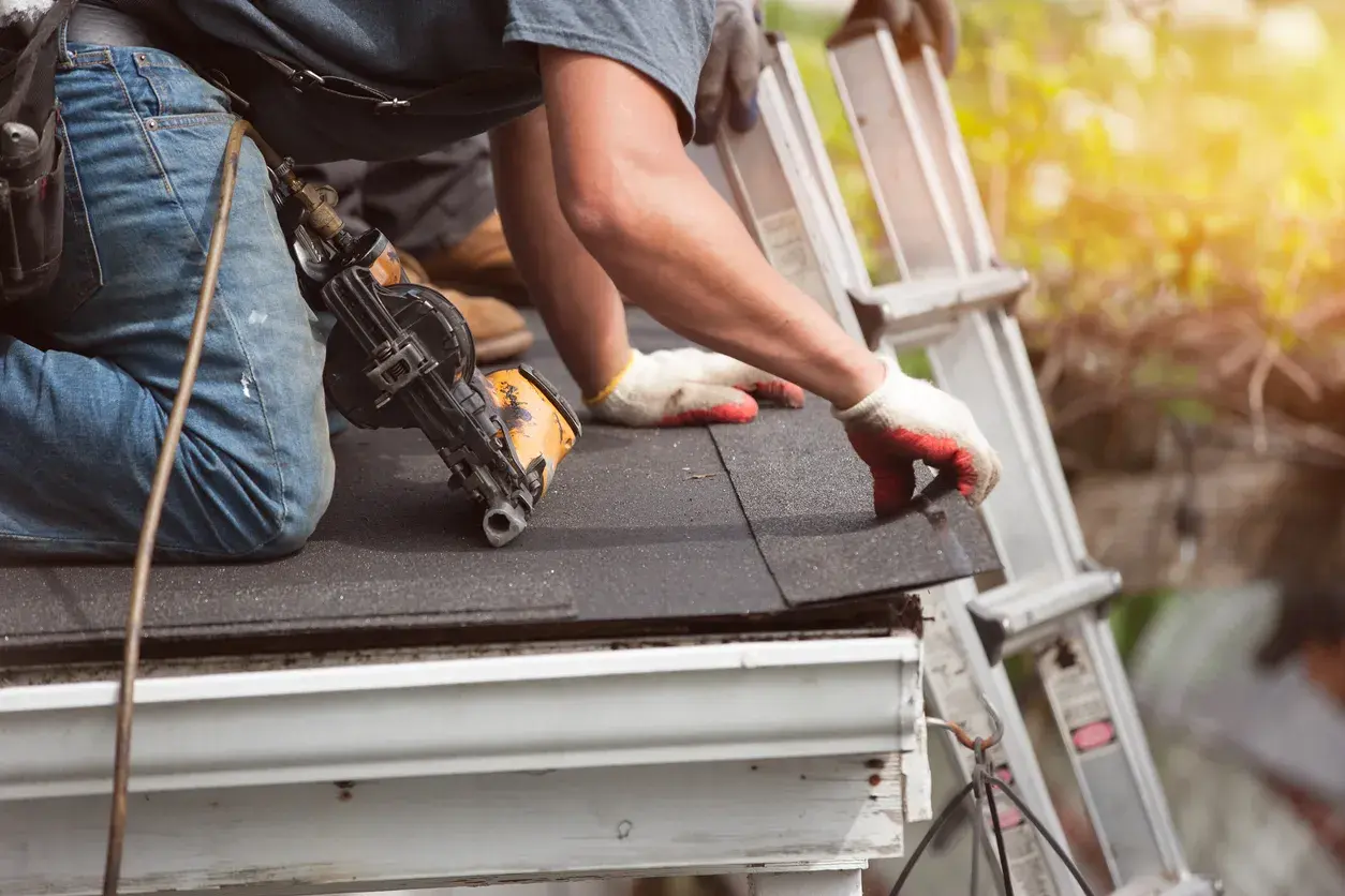an expert roofers on the roof with tools
