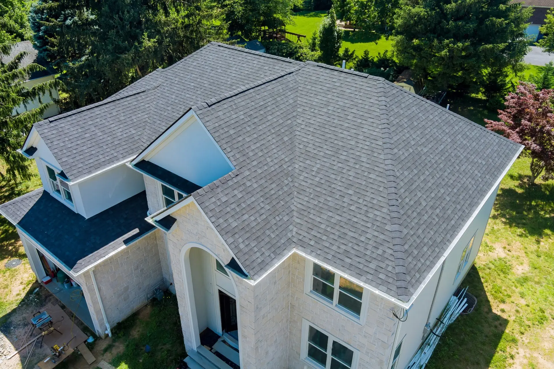 a newly installed shingle roofing on a beautiful house