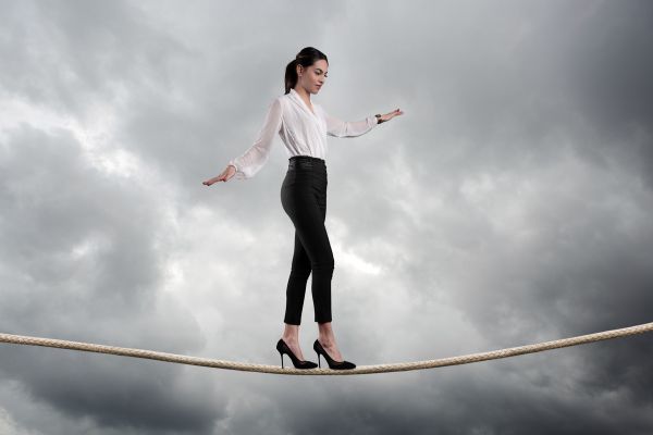 Woman Walking On A Tightrope