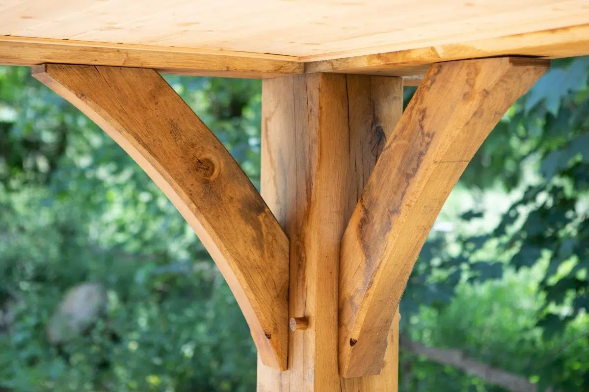 Oak frame joint showcasing traditional joinery techniques, emphasizing durability and aesthetic appeal for listed building extensions.