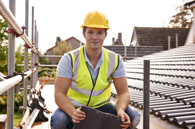 roofing expert sitting on the roof