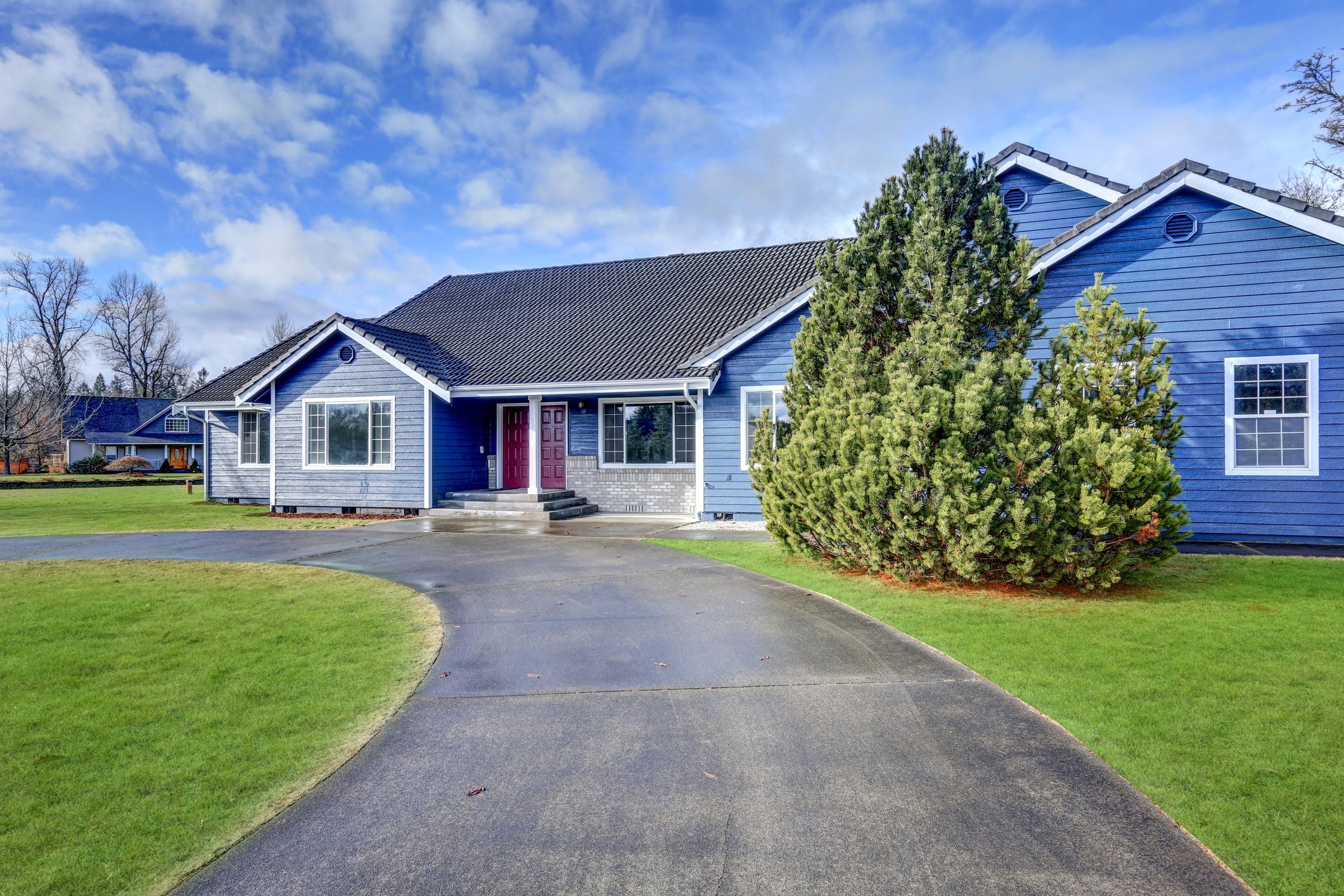 new concrete driveway in front of blue house