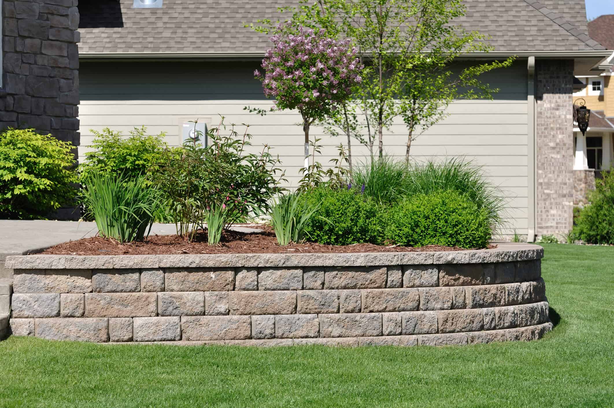 retaining walls in backyard with elevated flowerbeds