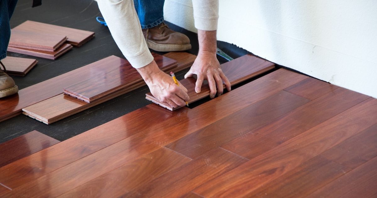 man installing a brown tile man installing a brown tile