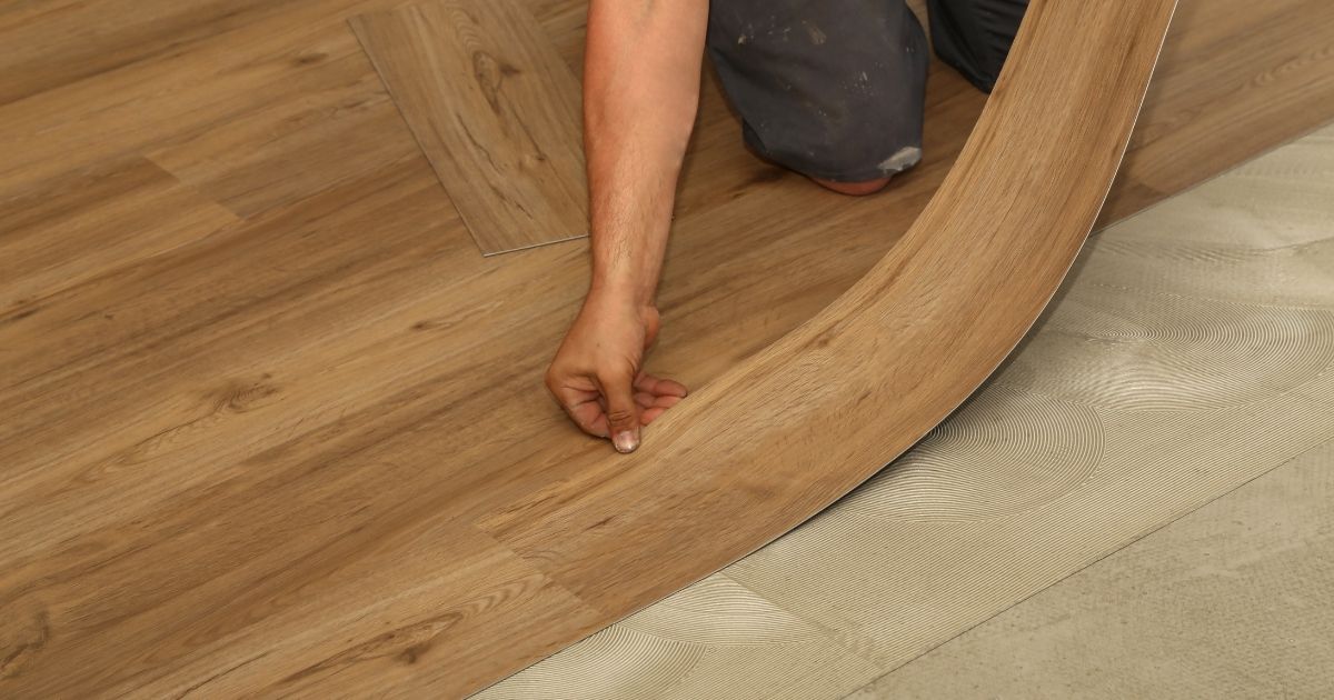 man installing brown vinyl man installing brown vinyl