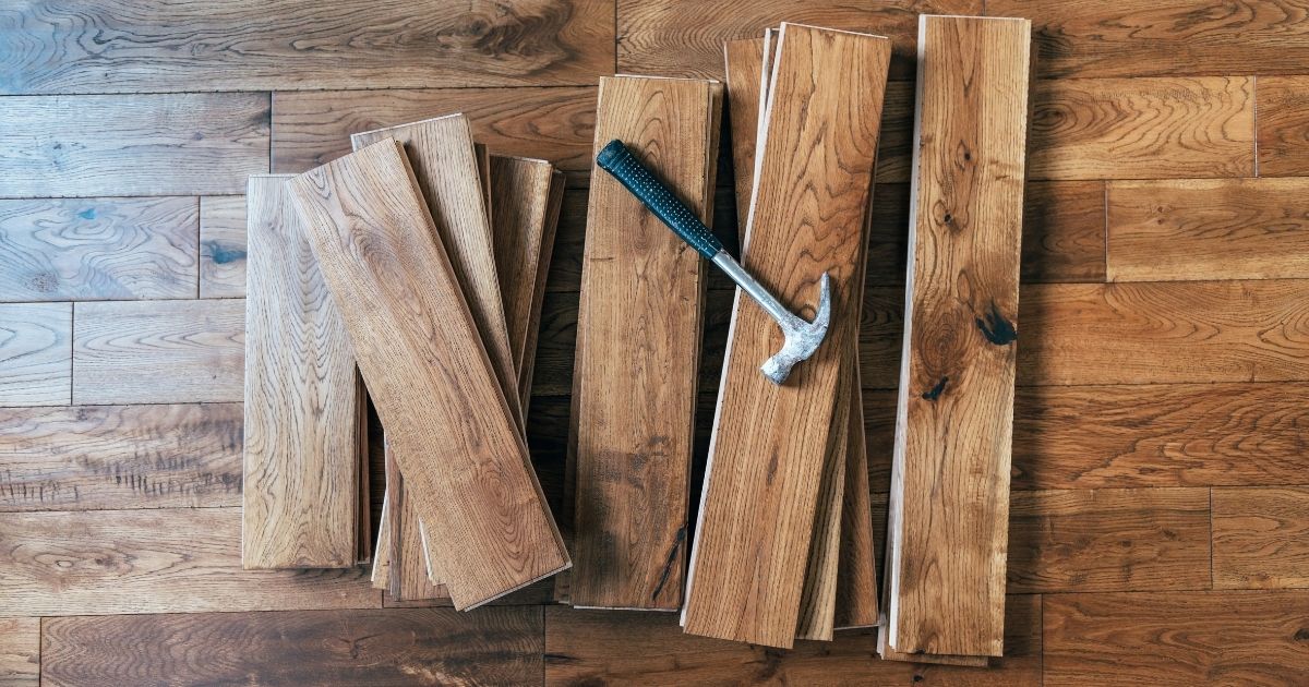 Stack of wooden floor planks with a hammer on top Stack of wooden floor planks with a hammer on top