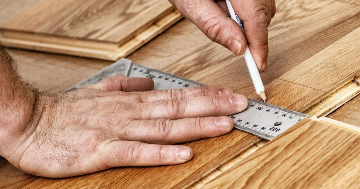 man measuring the floor