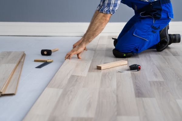 Man installing hardwood flooring Man installing hardwood flooring