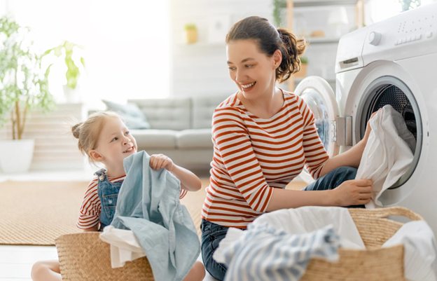 mom and daughter doing laundry mom and daughter doing laundry