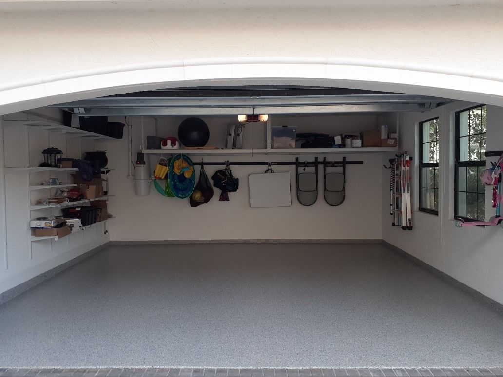 A white car in a garage with a finished floor