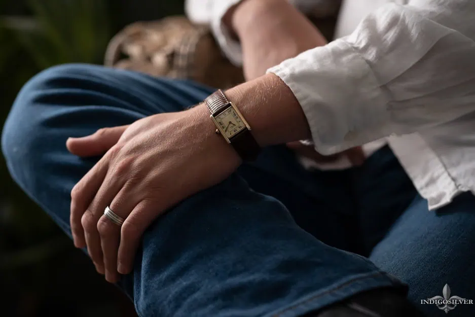 a male boudoir photo of a man's watch and wedding ring as his hand rests on his knee a male boudoir photo of a man's watch and wedding ring as his hand rests on his knee