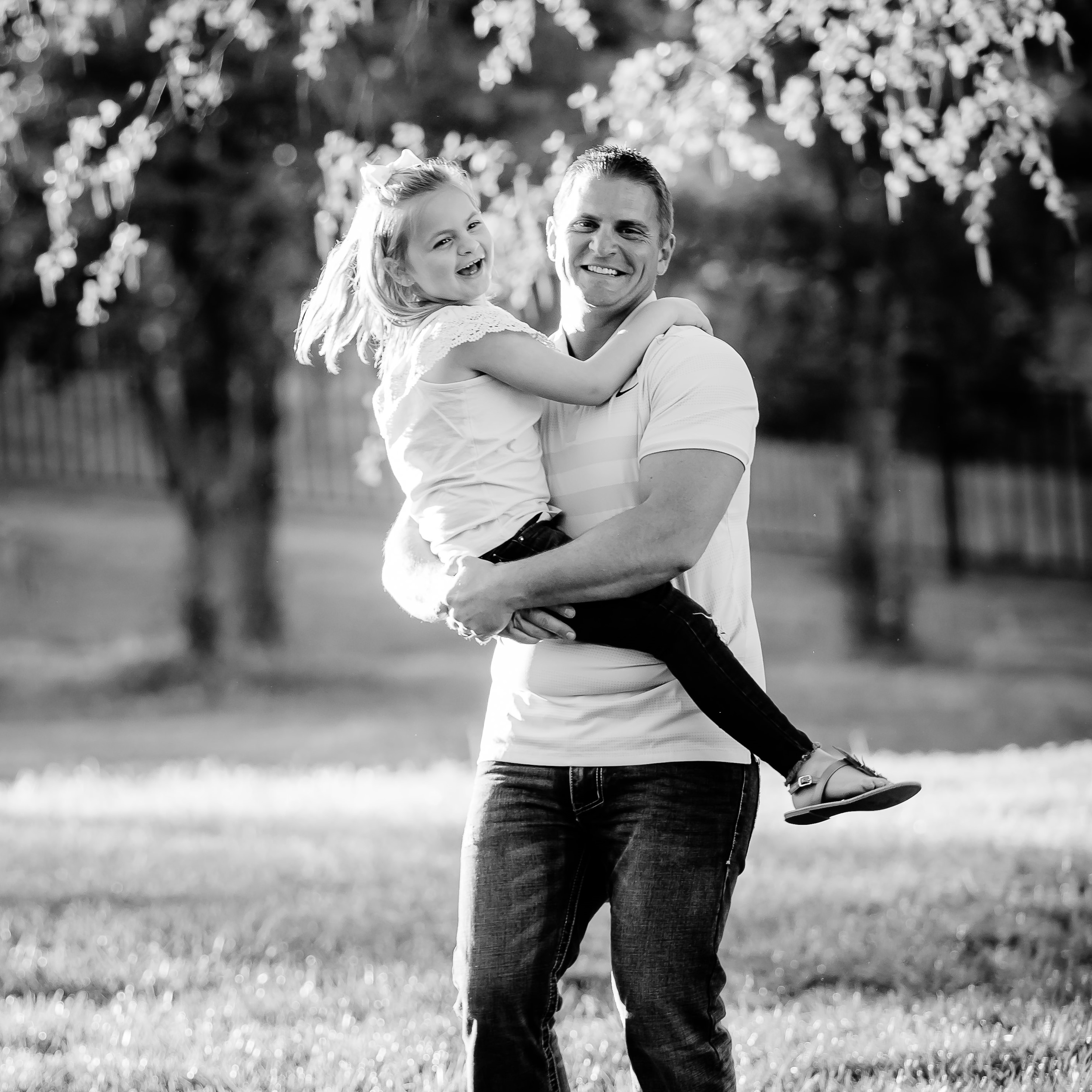 father carrying his daughter happily
