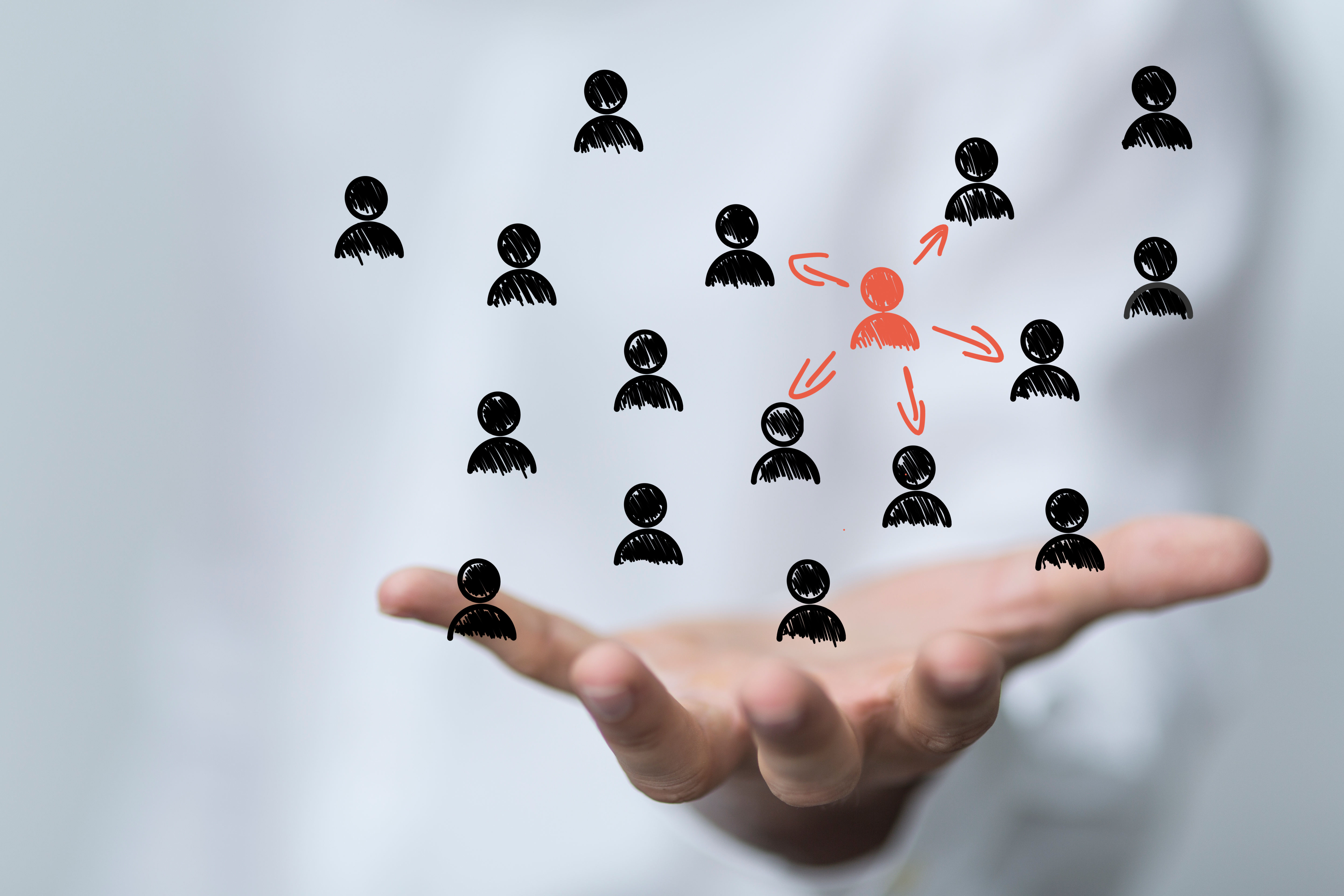 Hand holding illustrated network of people with central figure connected to others, representing leadership, influence, or network marketing. Hand holding illustrated network of people with central figure connected to others, representing leadership, influence, or network marketing.