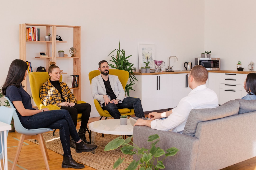 Casual team meeting in a modern office lounge, featuring diverse professionals discussing strategy and collaboration in a creative workspace environment. Casual team meeting in a modern office lounge, featuring diverse professionals discussing strategy and collaboration in a creative workspace environment.