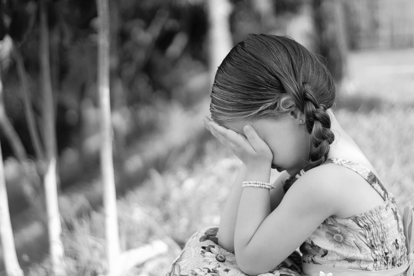 child with head in hands child with head in hands
