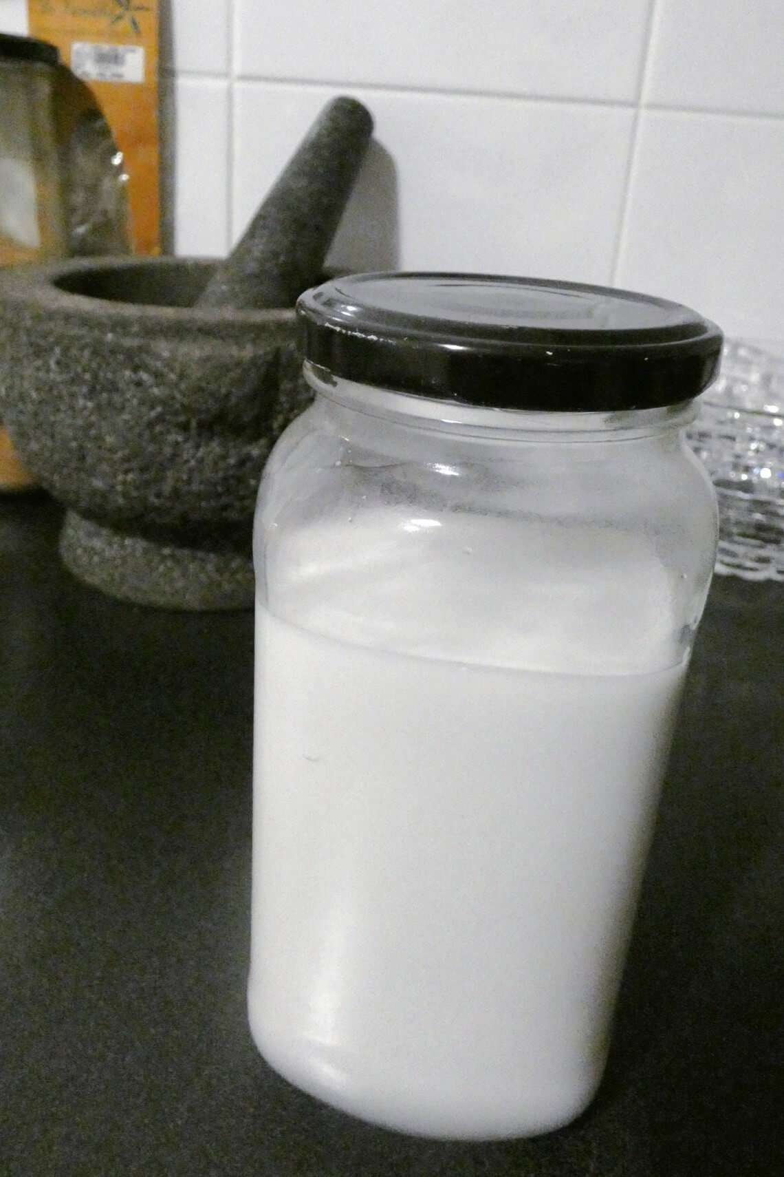 Fresh coconut milk in a glass jar Fresh coconut milk in a glass jar