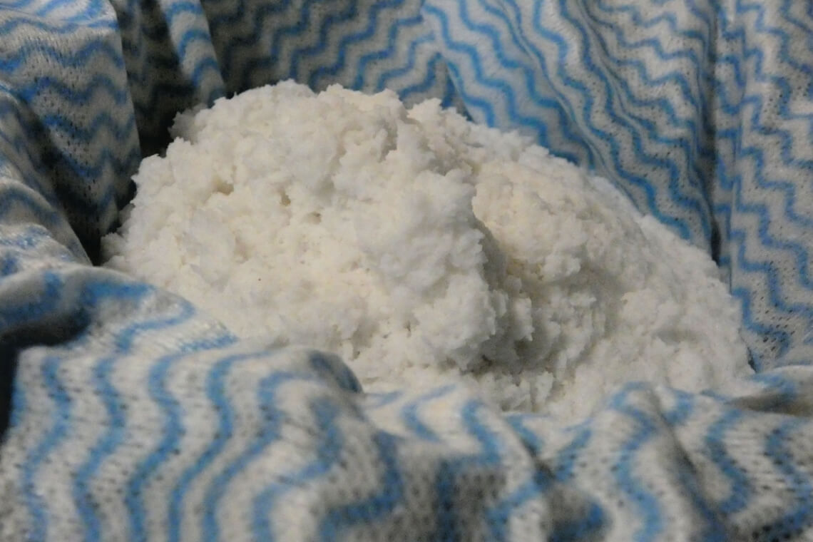 Shredded coconut in a muslin cloth Shredded coconut in a muslin cloth