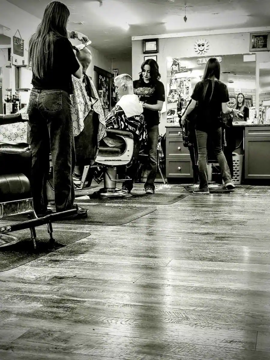 The girls cutting hair at AJ Barbershop