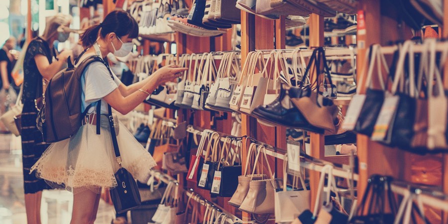 Woman, browsing shoes in shop