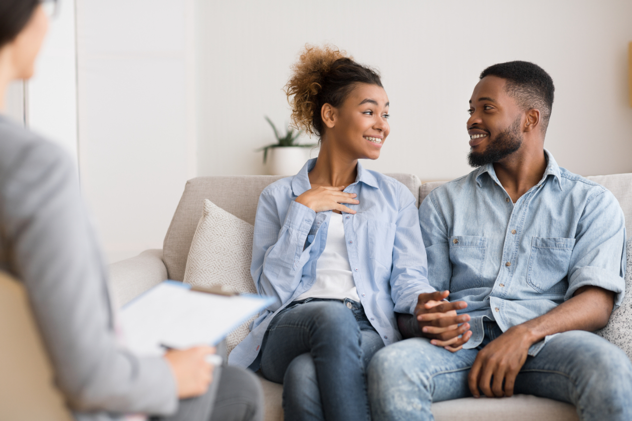 Cheerful Couple Sharing With Marital Therapist After Reconciliation
