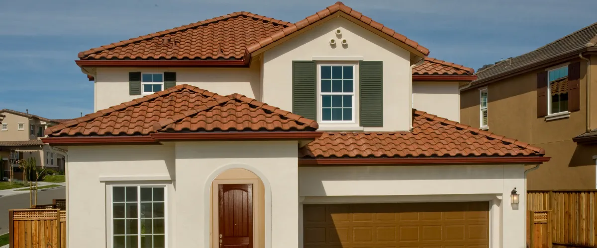 Spanish style home with red tile roof and white exterior walls Spanish style home with red tile roof and white exterior walls