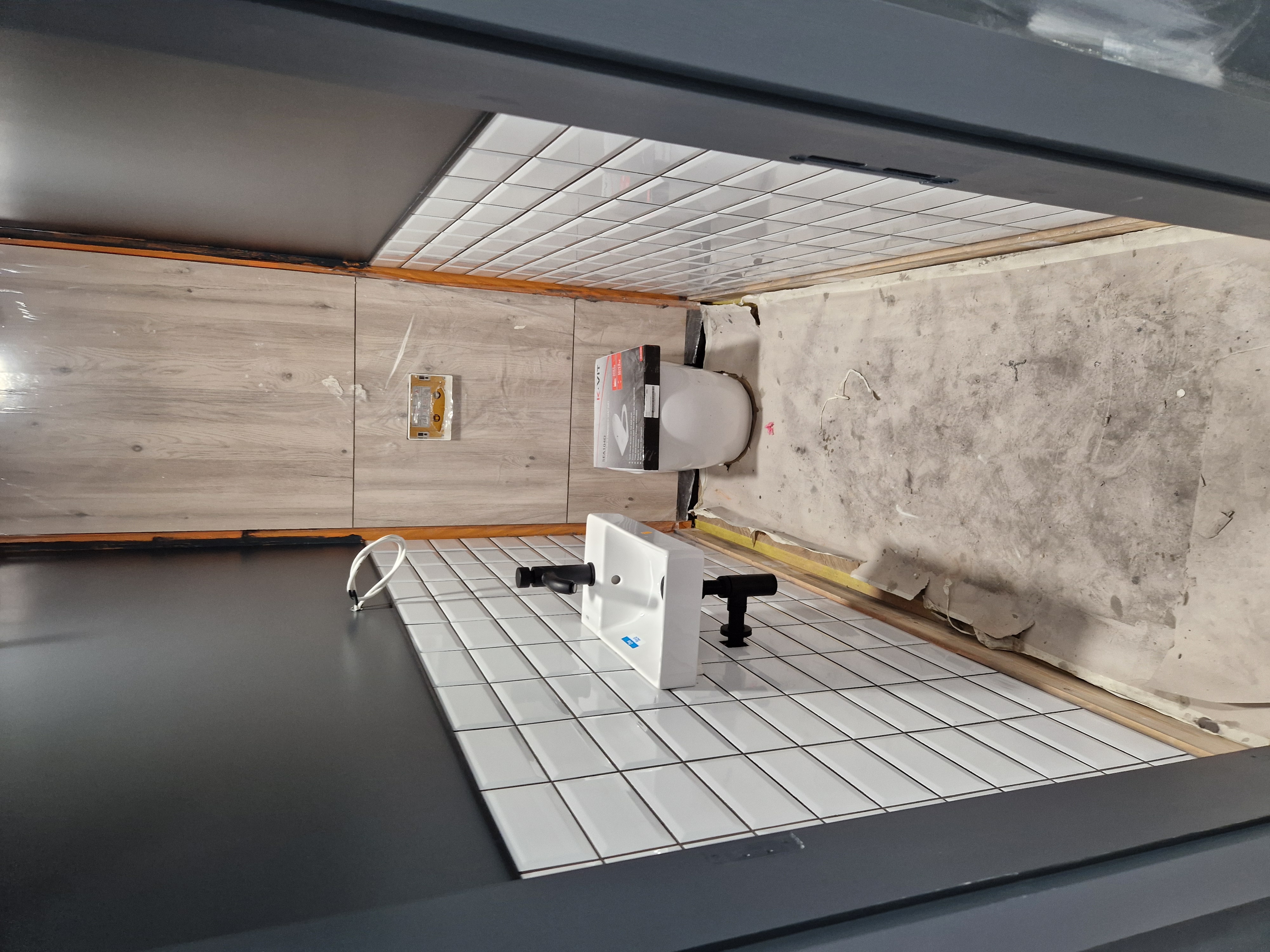 Dulwich SE22 — first-fix washroom plumbing with wall-hung WC frames.