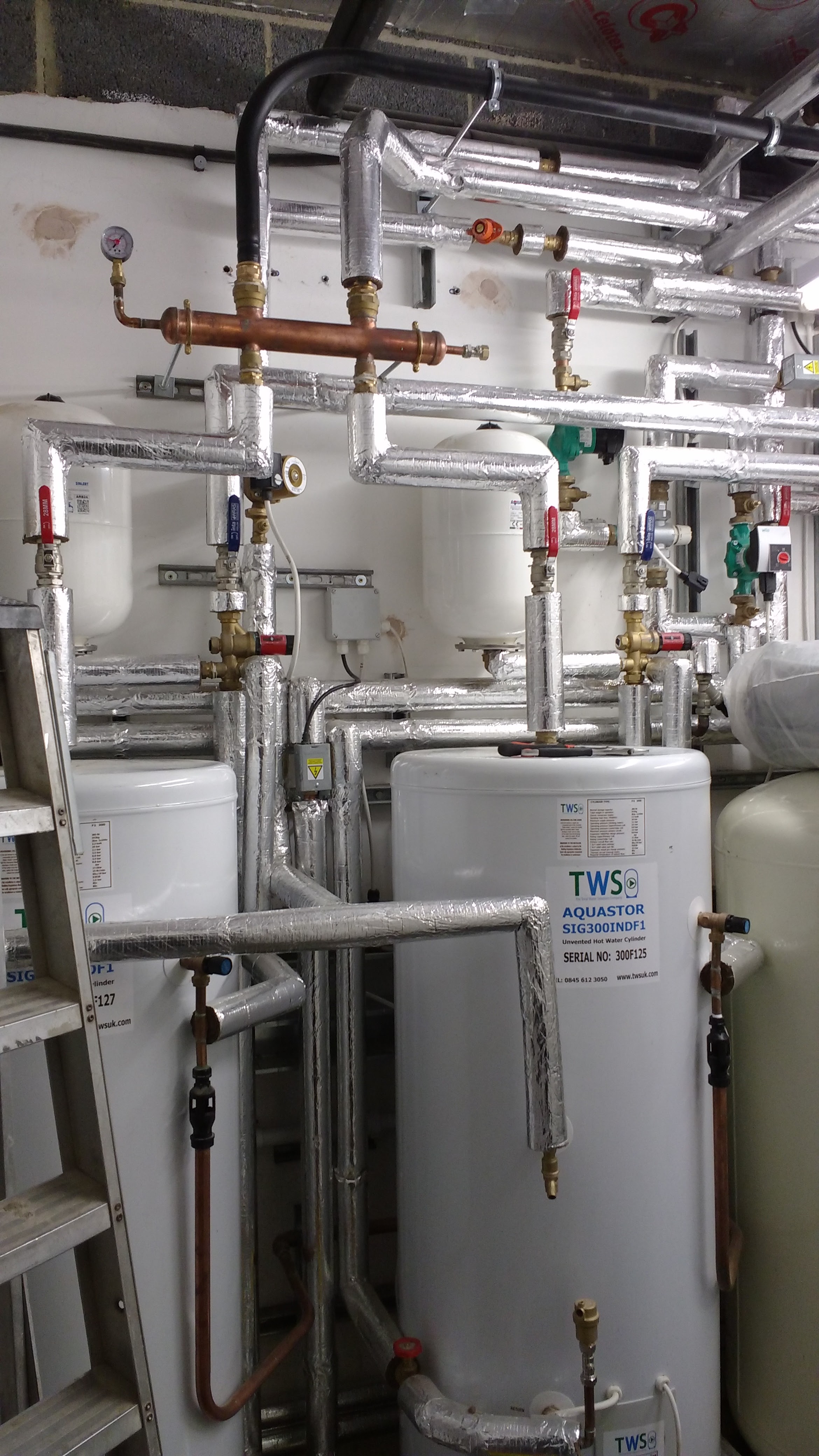 Bedford Road HA6 — high-end hybrid plantroom installation with boilers, heat pump integration, and unvented cylinders. Bedford Road HA6 — high-end hybrid plantroom installation with boilers, heat pump integration, and unvented cylinders.