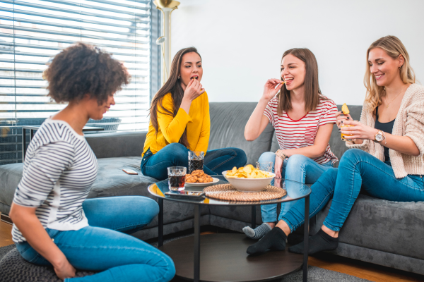 women on sofa laughing and having fun