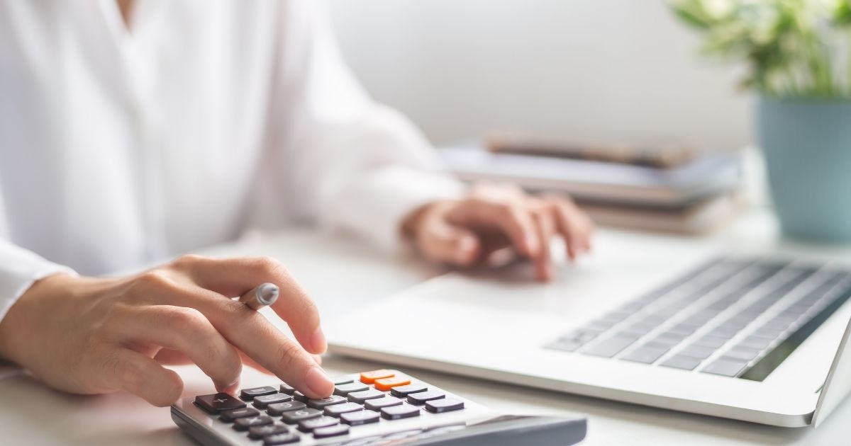 man using calculator and laptop man using calculator and laptop