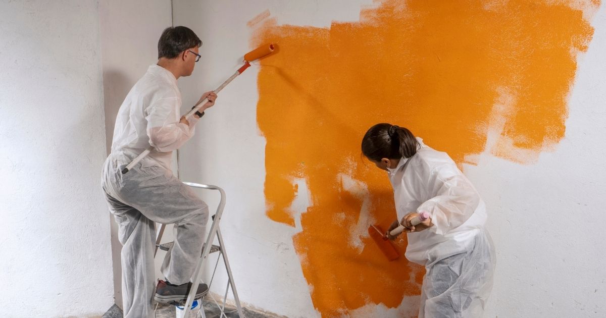 people painting orange wall people painting orange wall
