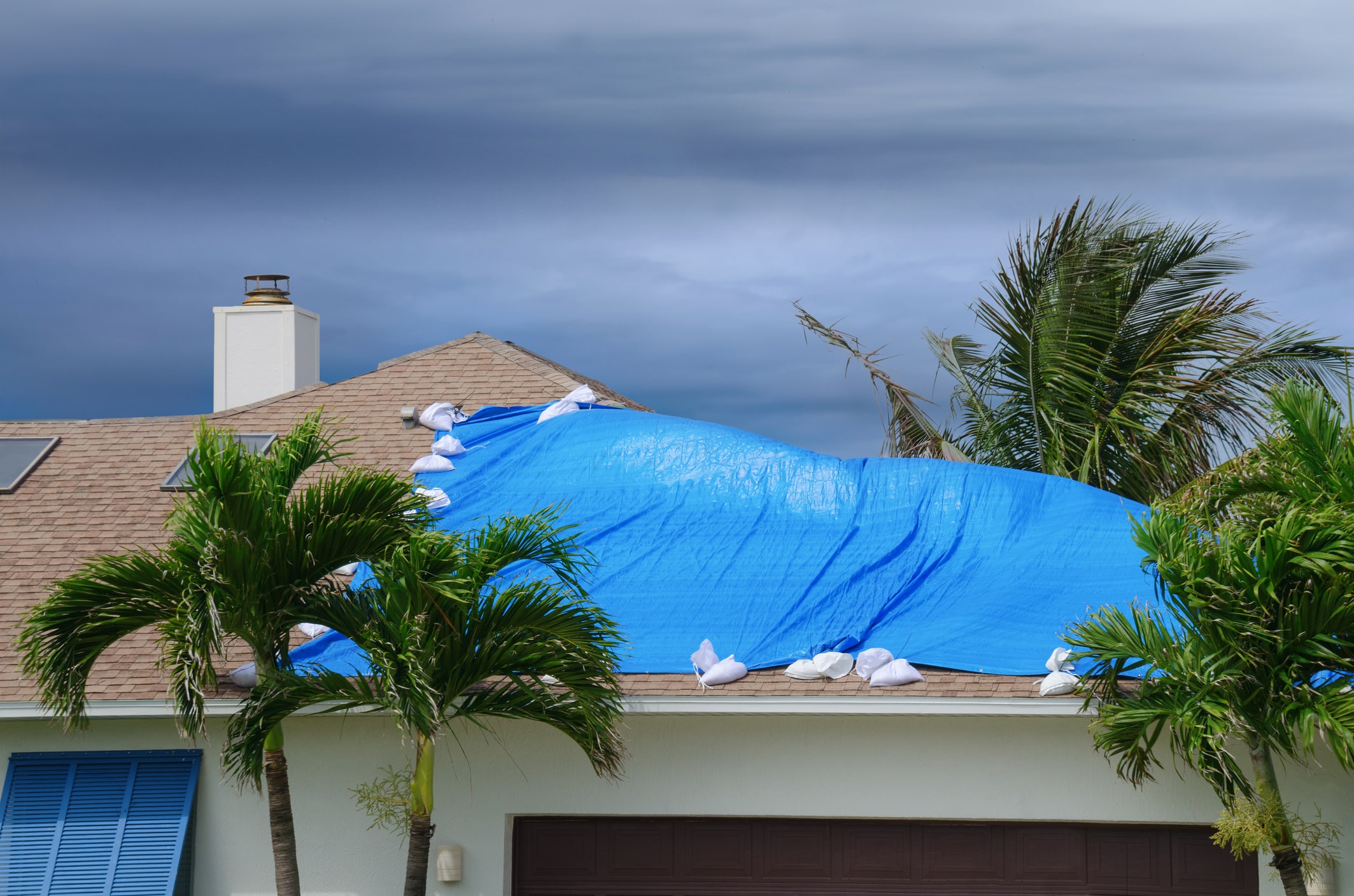 expert roofers fixing damaged roof