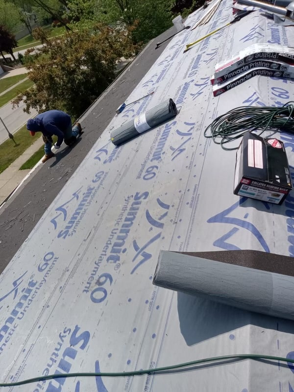 C&H Exterior Roofing contractor installing new tiles on roof