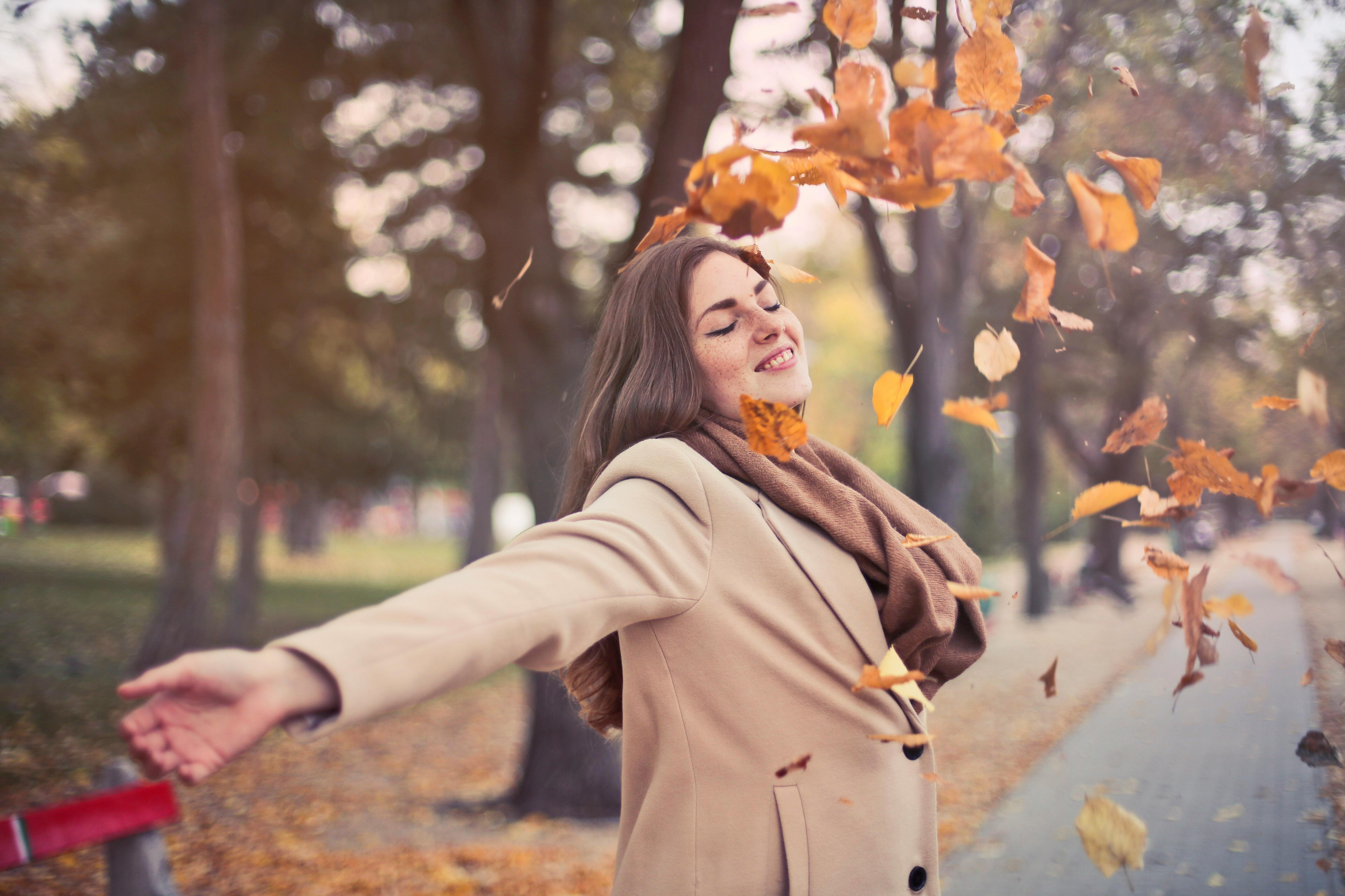 A woman celebrating her freedom from anxiety thanks to hypnosis near me