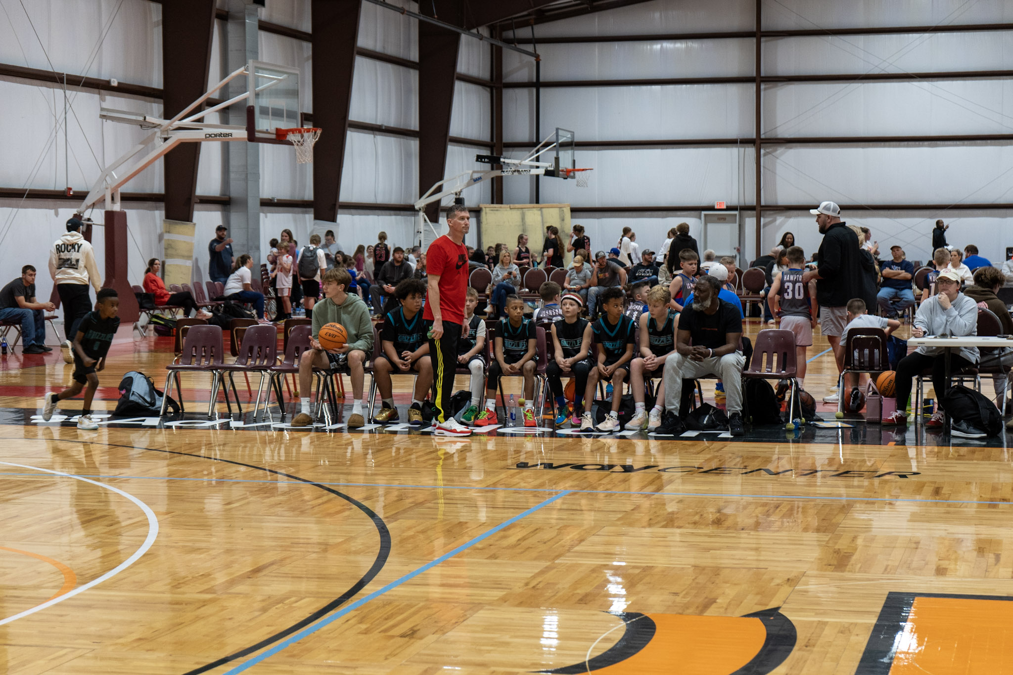 Boys team sitting on bench with basketball coach