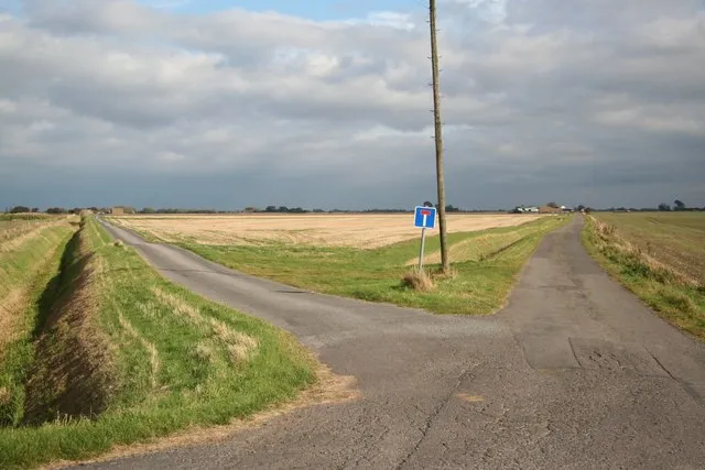A country road forking into two paths — representing the developmental choices and open windows in youth athletics