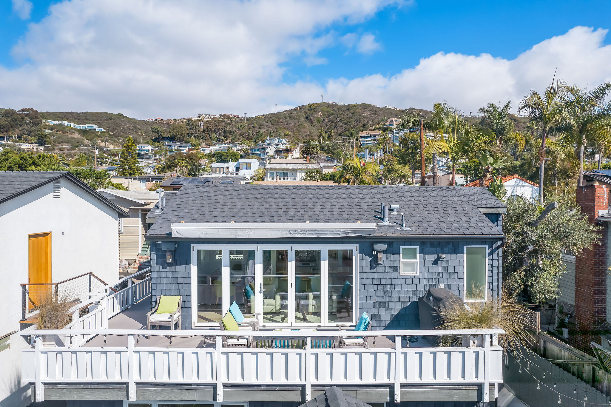 Aerial view of a luxury oceanside home with ocean views, surrounded by other homes and sand, ideal for Airbnb or vacation rental investment. Aerial view of a luxury oceanside home with ocean views, surrounded by other homes and sand, ideal for Airbnb or vacation rental investment.
