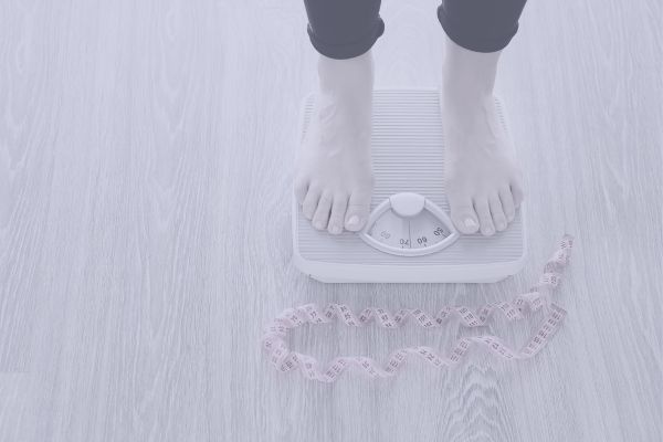 menopausal woman stood on scales