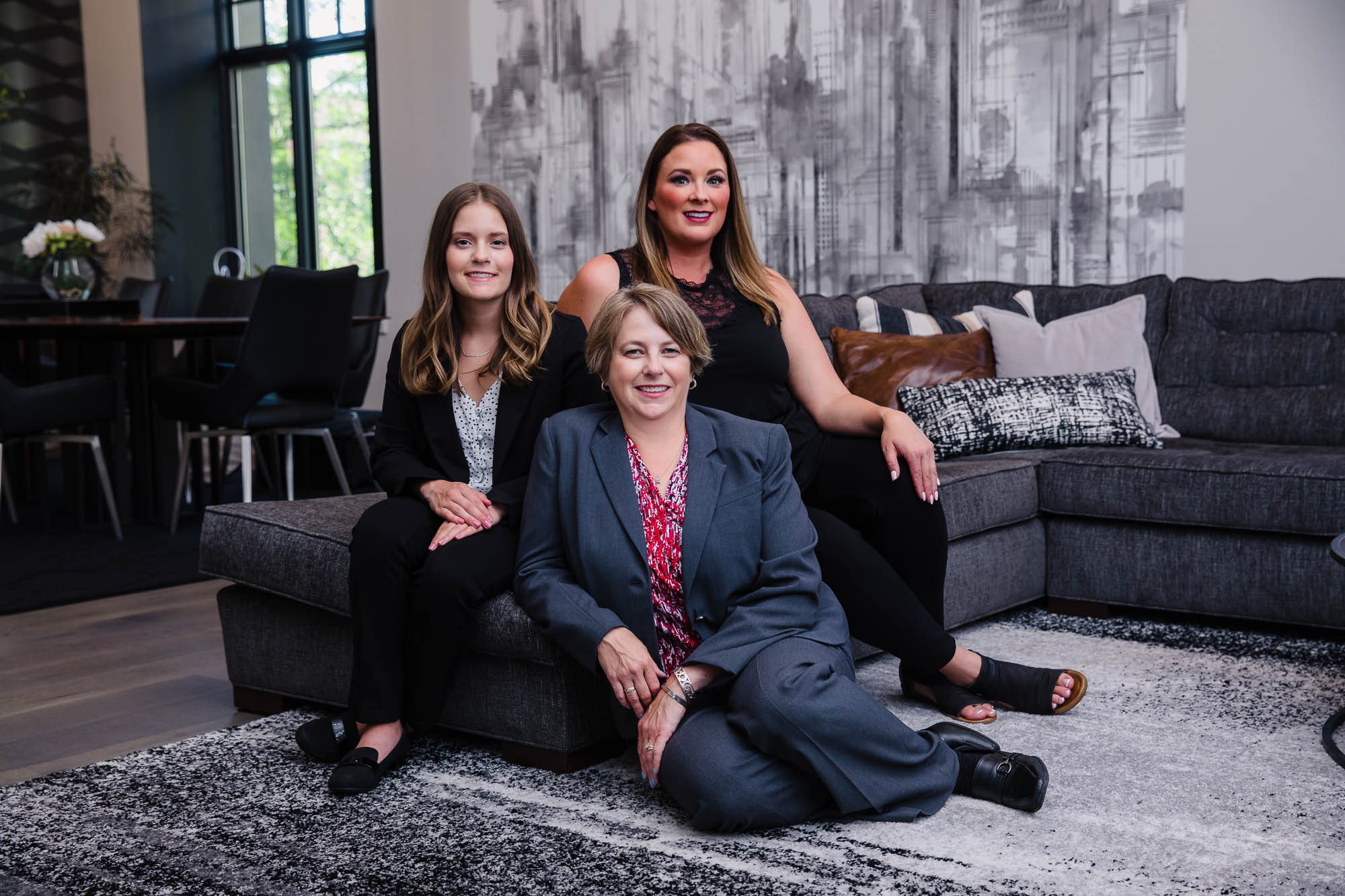 real east agent team posing in a staged home for a branding photoshoot in spokane real east agent team posing in a staged home for a branding photoshoot in spokane