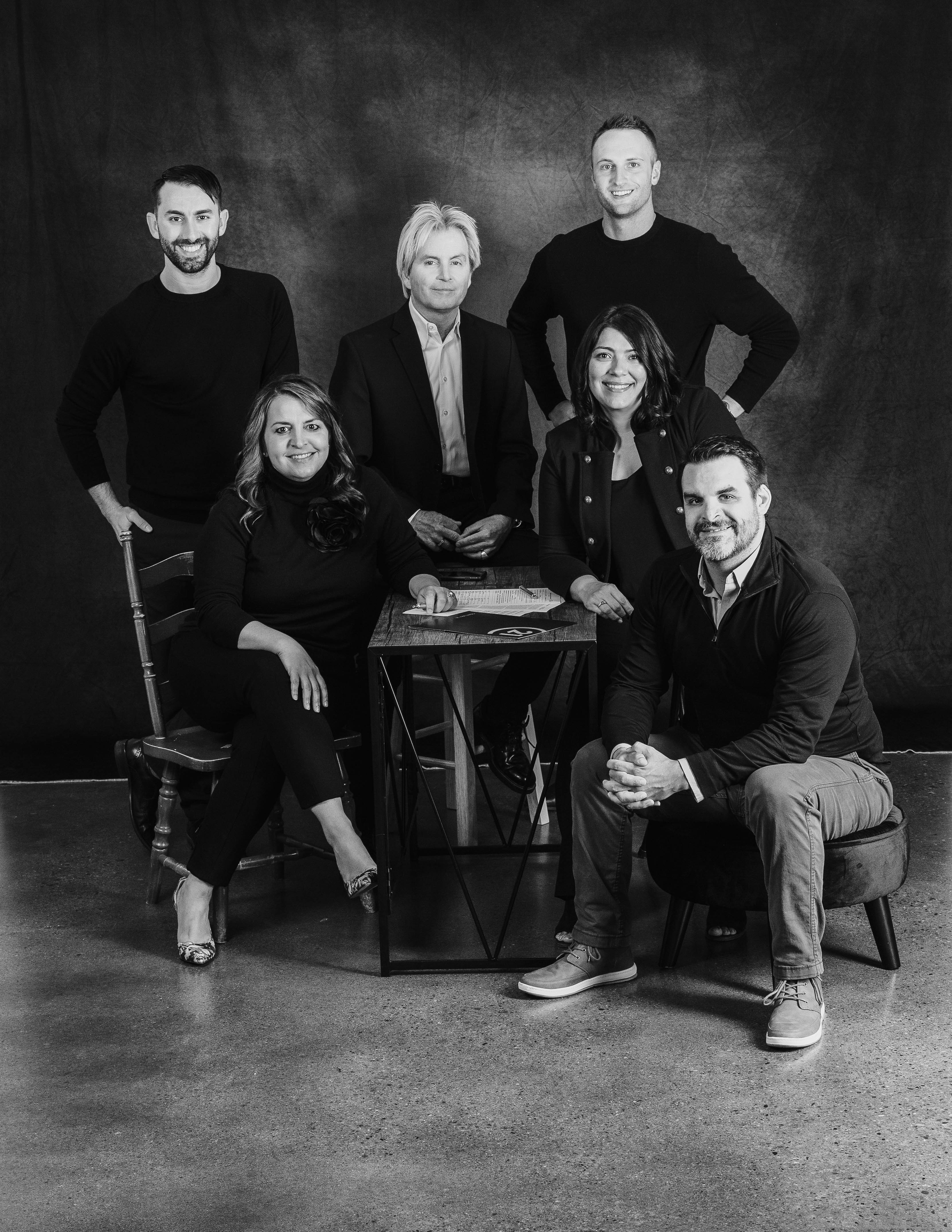 real estate agent team posing in rented Spokane photo studio with neutral backdrop real estate agent team posing in rented Spokane photo studio with neutral backdrop