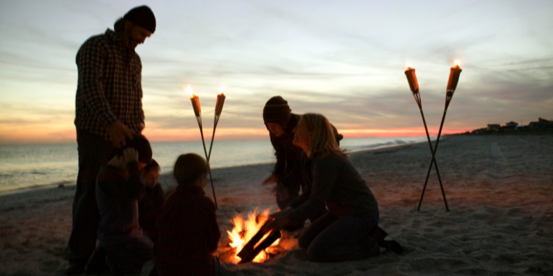 family in the beach with bonfire family in the beach with bonfire