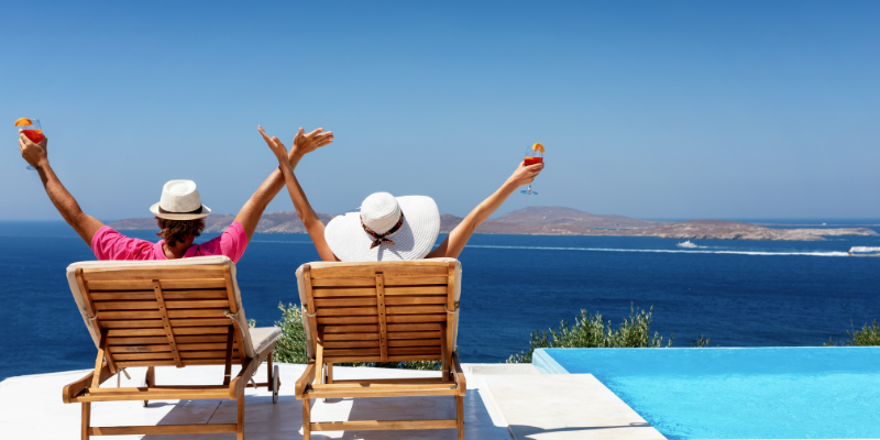 couple lounging by the infinity pool with a view couple lounging by the infinity pool with a view