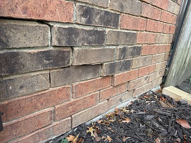 severe foundation settlement causing the brick veneer to shift and crack