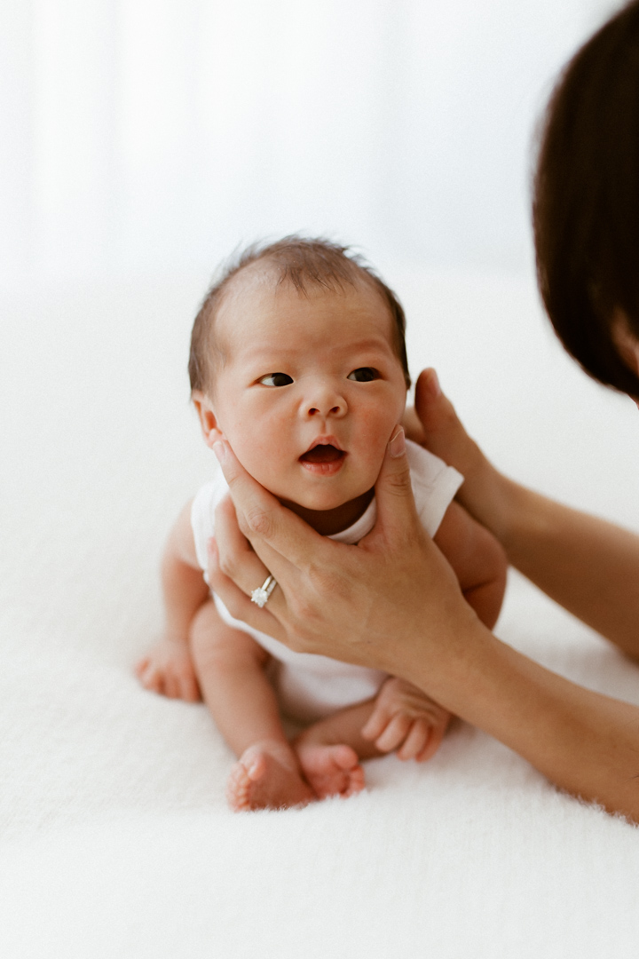 newborn baby looking at mum
