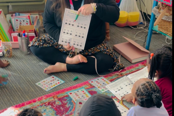 Annie teaches a small group while the rest of the class participates in play-based centers