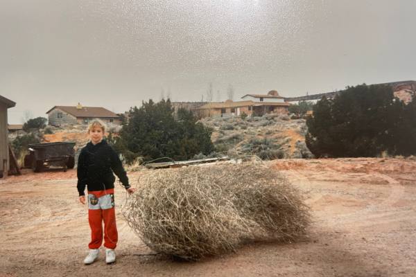 Ali as a child holding a tumbleweed