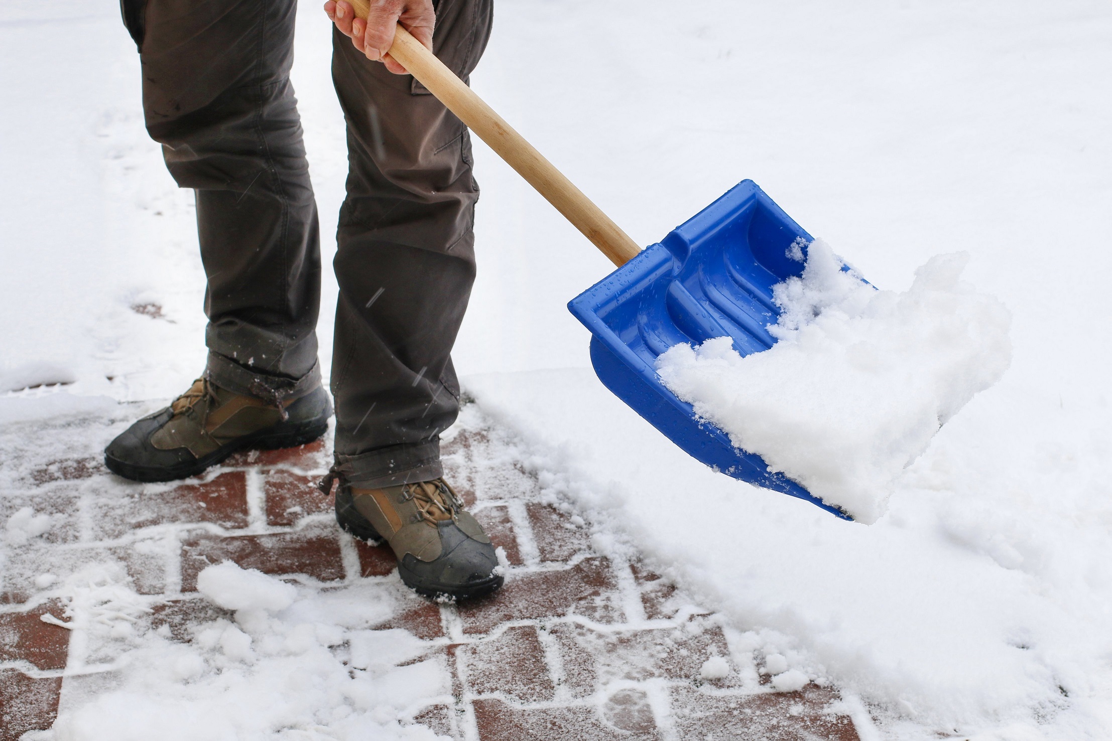 Snow plow clearing a residential driveway
