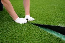 Artificial turf installation in backyard