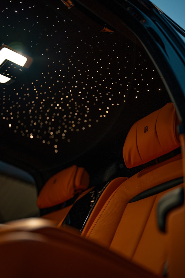 Luxury starlight headliner installation showing fiber optic stars creating celestial atmosphere in vehicle interior
