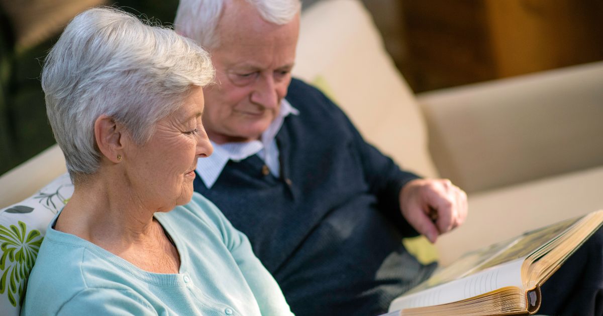 A family gathered around a dining table, reviewing funeral pre-planning documents. A family gathered around a dining table, reviewing funeral pre-planning documents.