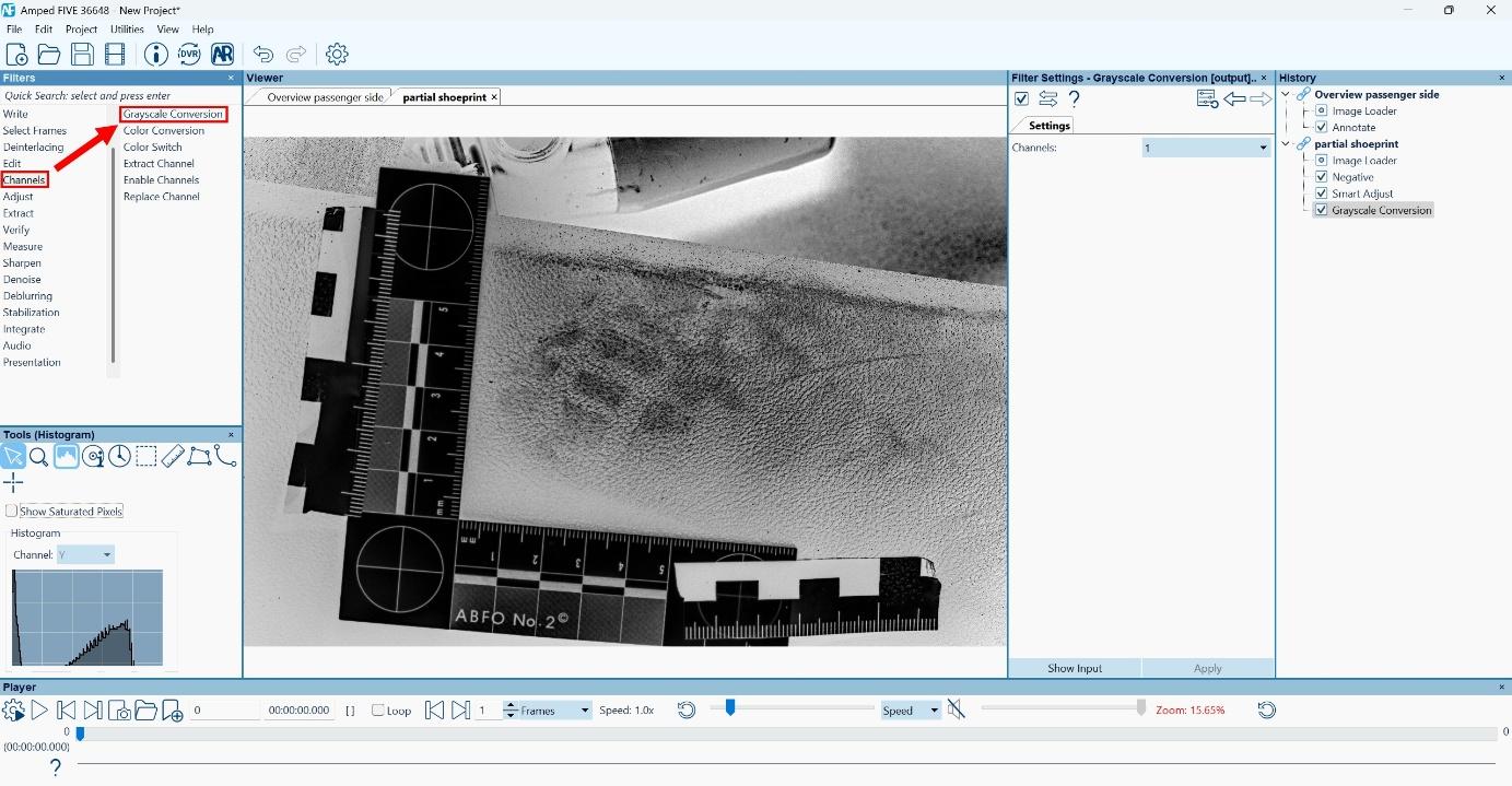 Screenshot of the Amped FIVE interface showing the application of the “Grayscale Conversion” filter under the “Channels” category to enhance a partial shoeprint. The shoeprint is located on a textured surface with an L-shaped ABFO No. 2 scale in the scene. The image has undergone previous filters, including “Negative” and “Smart Adjust,” as indicated in the filter history panel. Red arrow highlight the selected Grayscale filter. The grayscale conversion enhances contrast for forensic analysis and visualization of the latent footwear impression. Screenshot of the Amped FIVE interface showing the application of the “Grayscale Conversion” filter under the “Channels” category to enhance a partial shoeprint. The shoeprint is located on a textured surface with an L-shaped ABFO No. 2 scale in the scene. The image has undergone previous filters, including “Negative” and “Smart Adjust,” as indicated in the filter history panel. Red arrow highlight the selected Grayscale filter. The grayscale conversion enhances contrast for forensic analysis and visualization of the latent footwear impression.